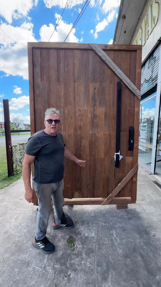 Our father next to a finished heart pine door with a long pull